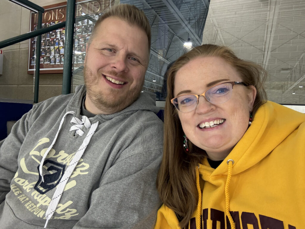 Photo of Adam and Tassy together at a hockey game
